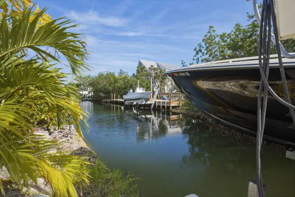 a view of a patio with table and chairs and potted plants