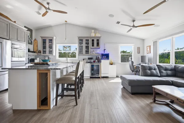 a view of a house with pool and chairs