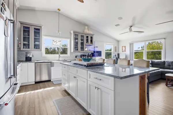 a aerial view of a house with swimming pool and lake view