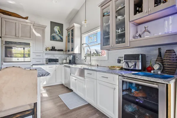 a aerial view of a house with swimming pool lawn chairs and a yard