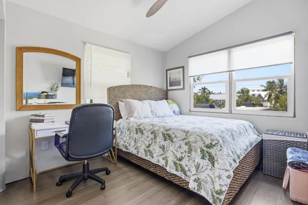 a balcony with wooden floor and outdoor seating