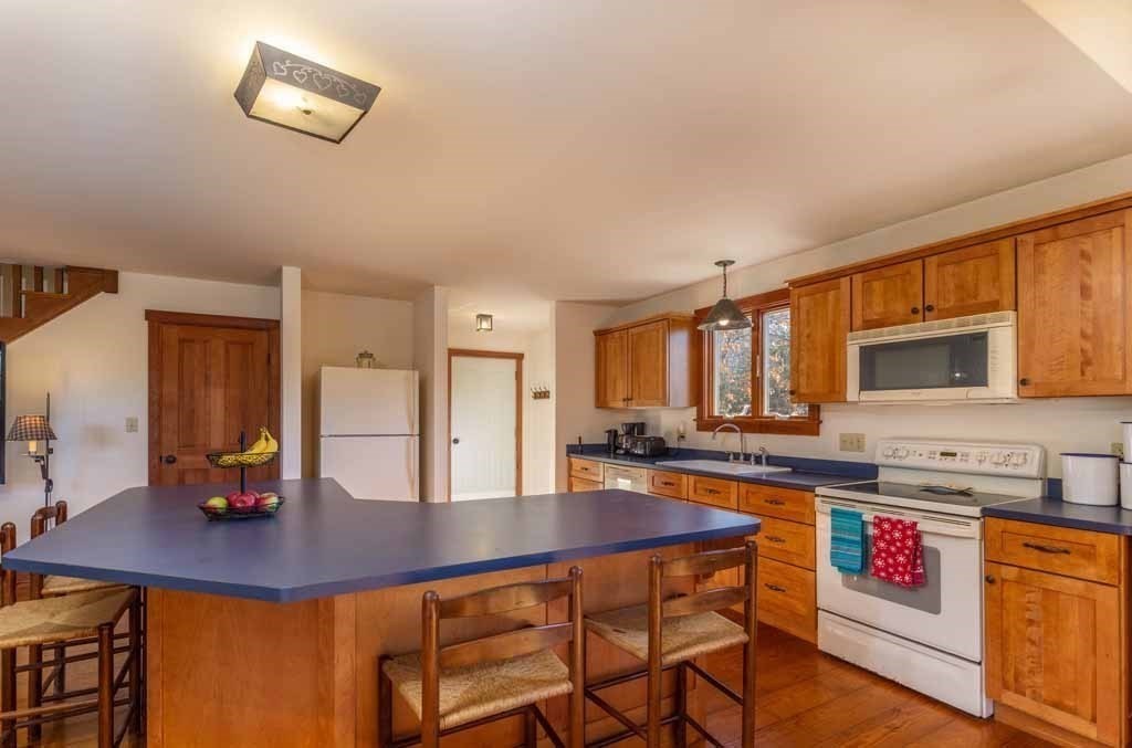 110 Whitney Road Phillipston, MA 01331 - Photo 4 of 26 a dining hall with stainless steel appliances granite countertop a dining table and chairs with wooden floor
