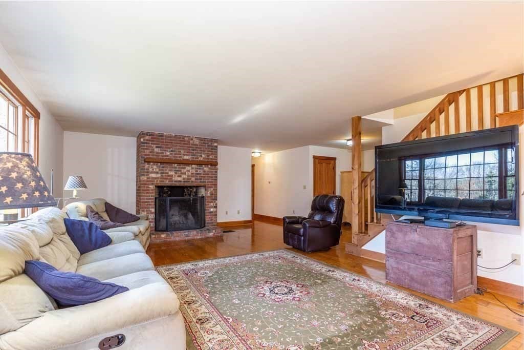110 Whitney Road Phillipston, MA 01331 - Photo 7 of 26 a living room with furniture a fireplace and a large window