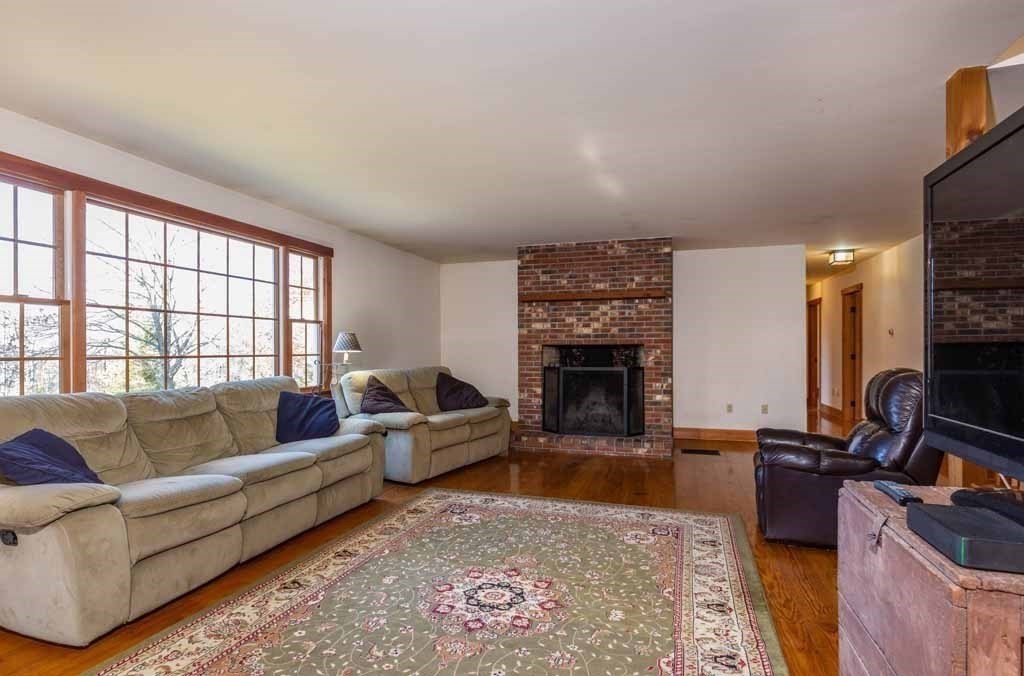 110 Whitney Road Phillipston, MA 01331 - Photo 8 of 26 a living room with furniture and a fireplace