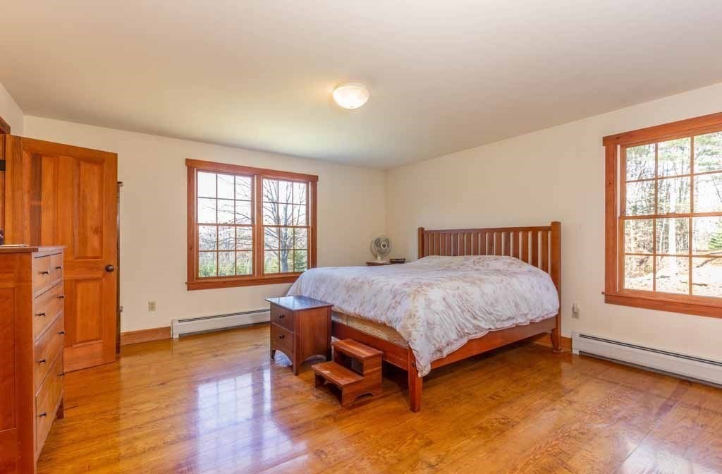110 Whitney Road Phillipston, MA 01331 - Photo 9 of 26 a spacious bedroom with a bed and wooden floor