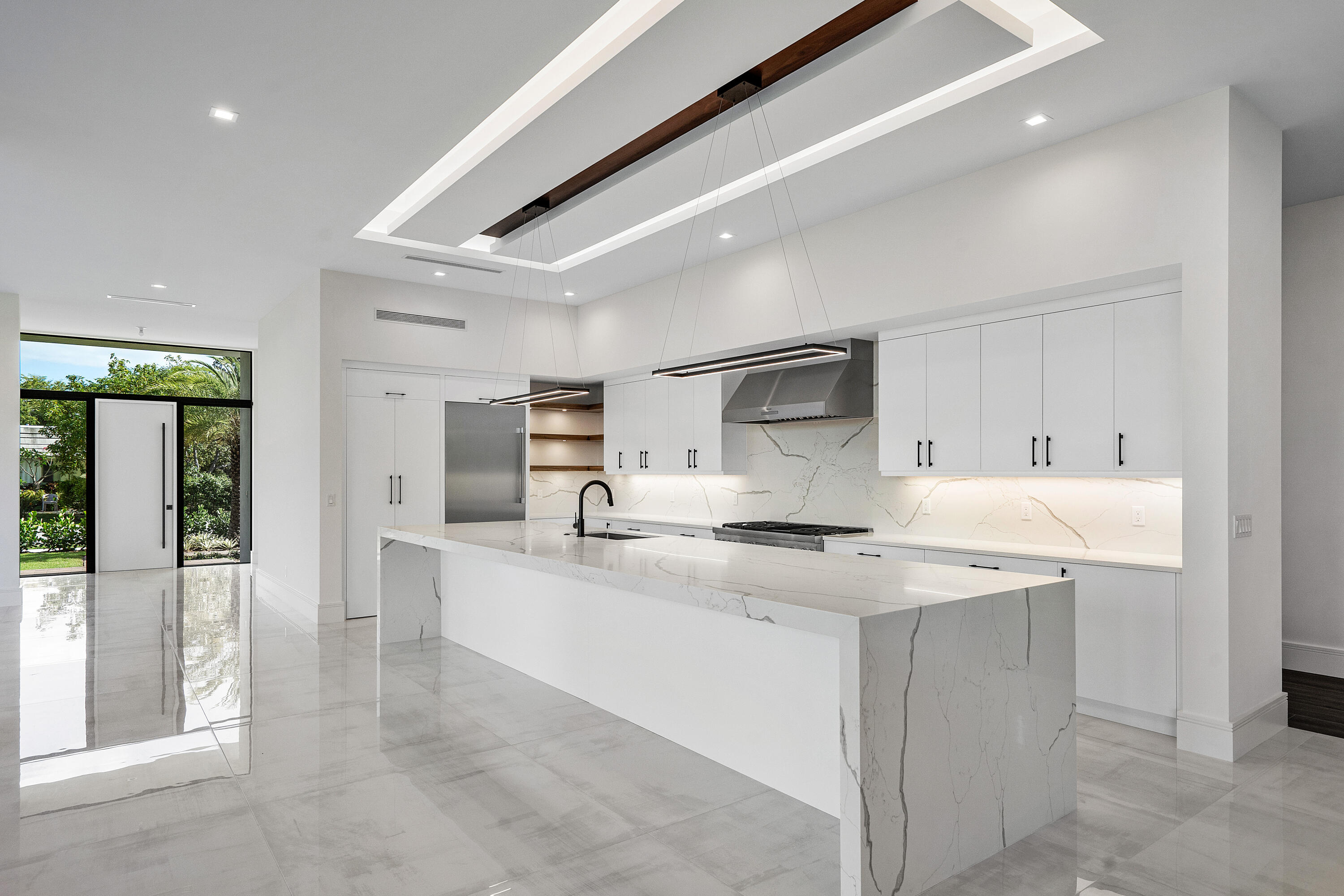10 Coconut Road Delray Beach, FL 33444 - Photo 5 of 41 a kitchen with stainless steel appliances a sink stove and cabinets