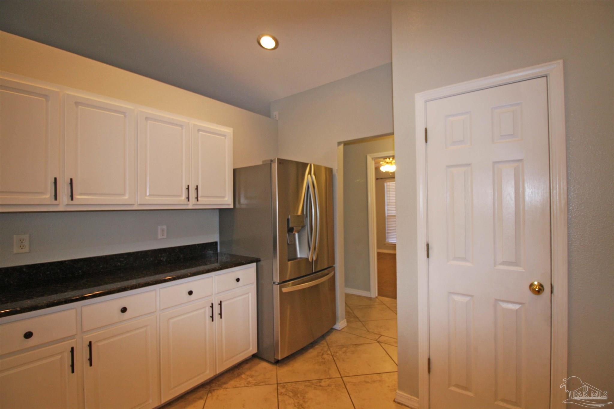 3735 Berrypatch Lane Pace, FL 32571 - Photo 16 of 46 a kitchen with stainless steel appliances a refrigerator and cabinets