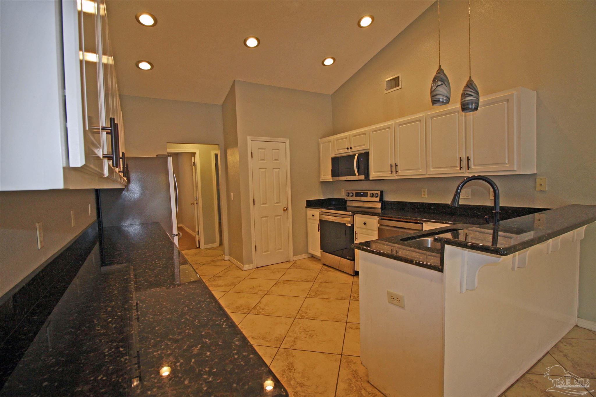 3735 Berrypatch Lane Pace, FL 32571 - Photo 17 of 46 a kitchen with stainless steel appliances a refrigerator and a stove
