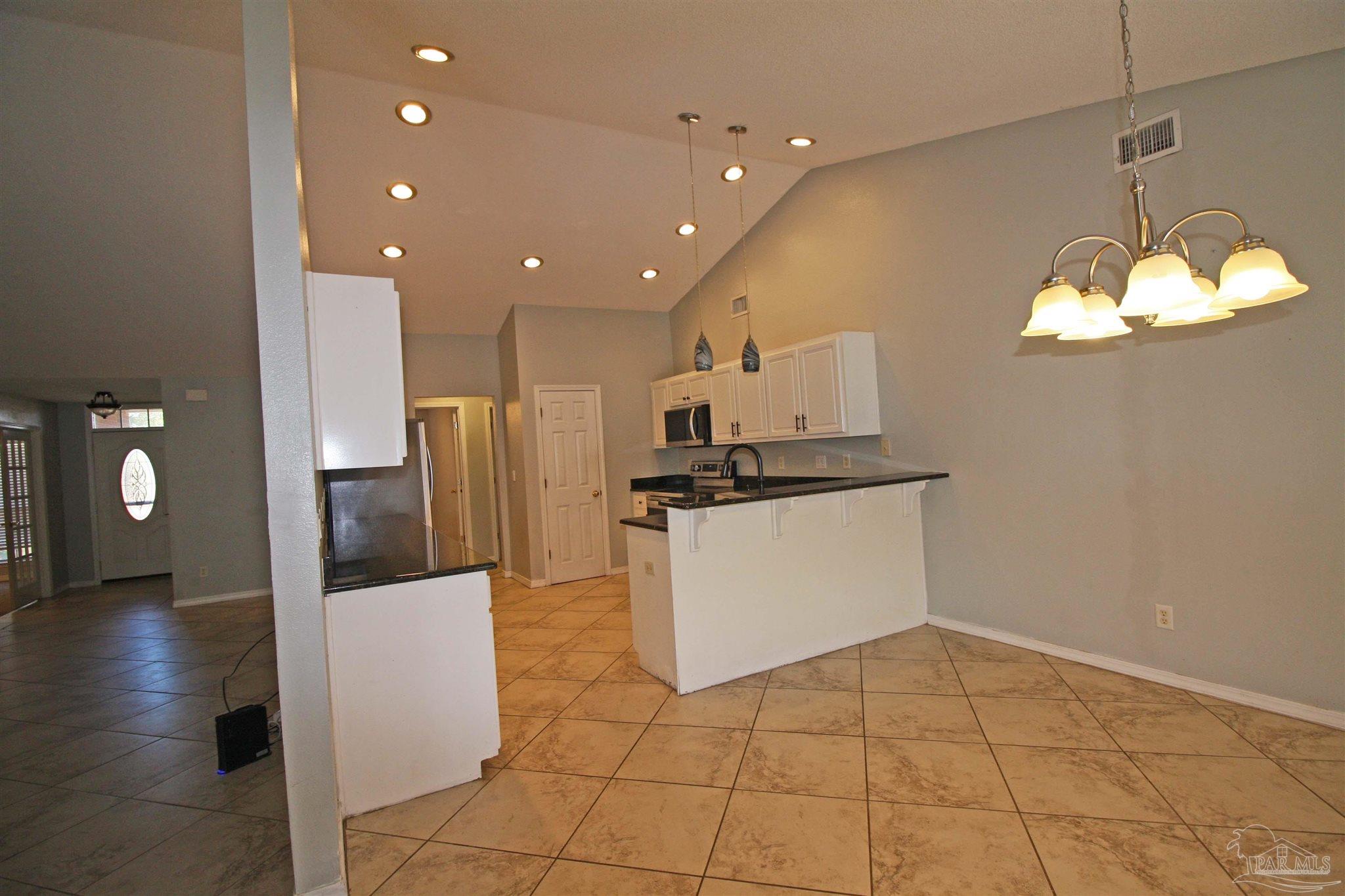 3735 Berrypatch Lane Pace, FL 32571 - Photo 22 of 46 a kitchen with stainless steel appliances a refrigerator and a stove top oven