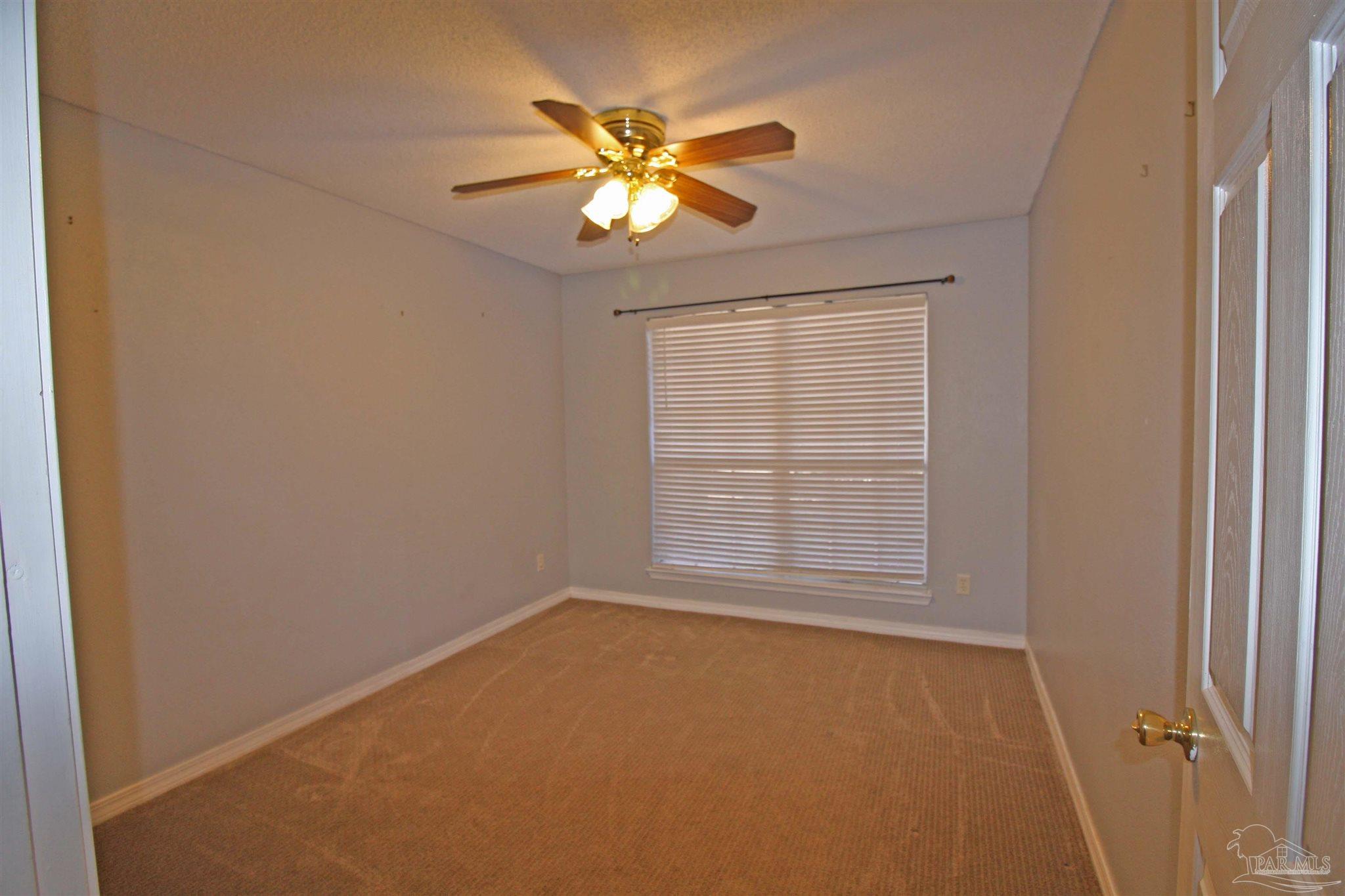 3735 Berrypatch Lane Pace, FL 32571 - Photo 24 of 46 an empty room with windows and fan
