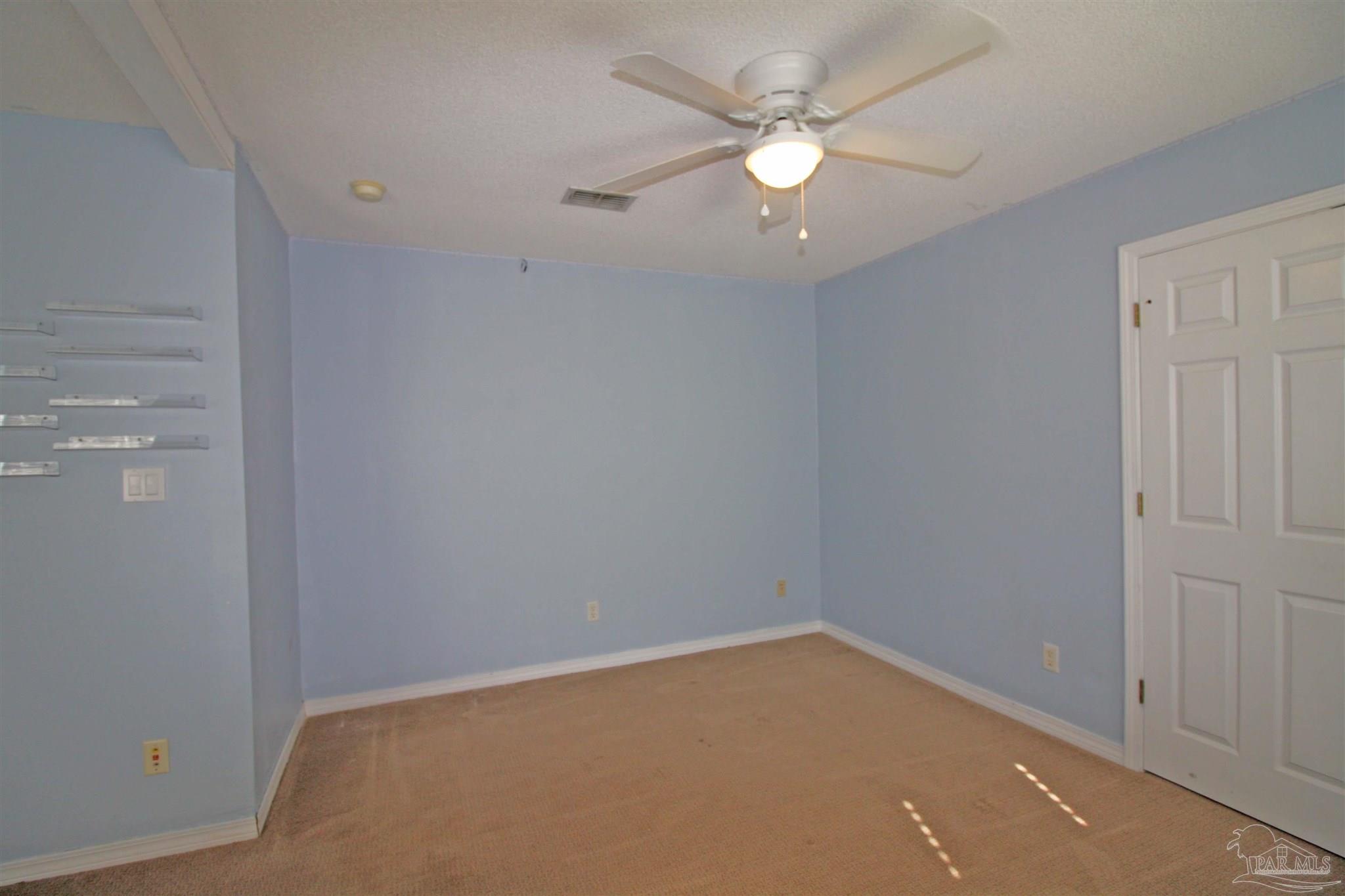 3735 Berrypatch Lane Pace, FL 32571 - Photo 31 of 46 an empty room with a ceiling fan and a window
