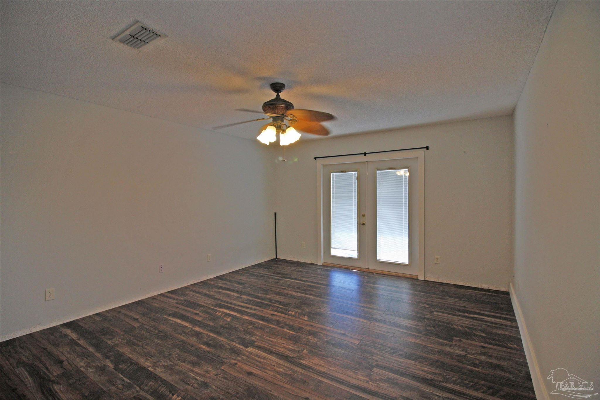 3735 Berrypatch Lane Pace, FL 32571 - Photo 36 of 46 a view of an empty room with wooden floor and a window