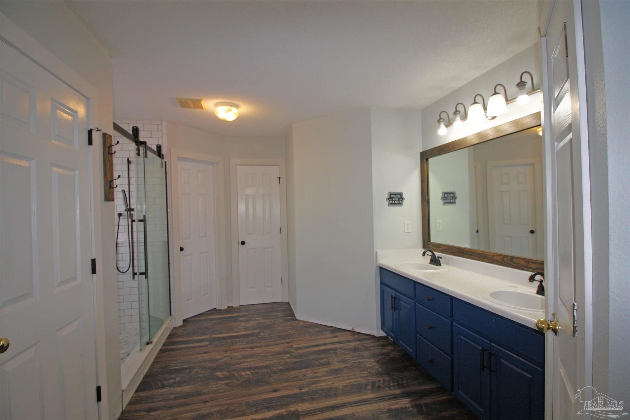 3735 Berrypatch Lane Pace, FL 32571 - Photo 38 of 46 a bathroom with a double vanity sink and mirror with shower