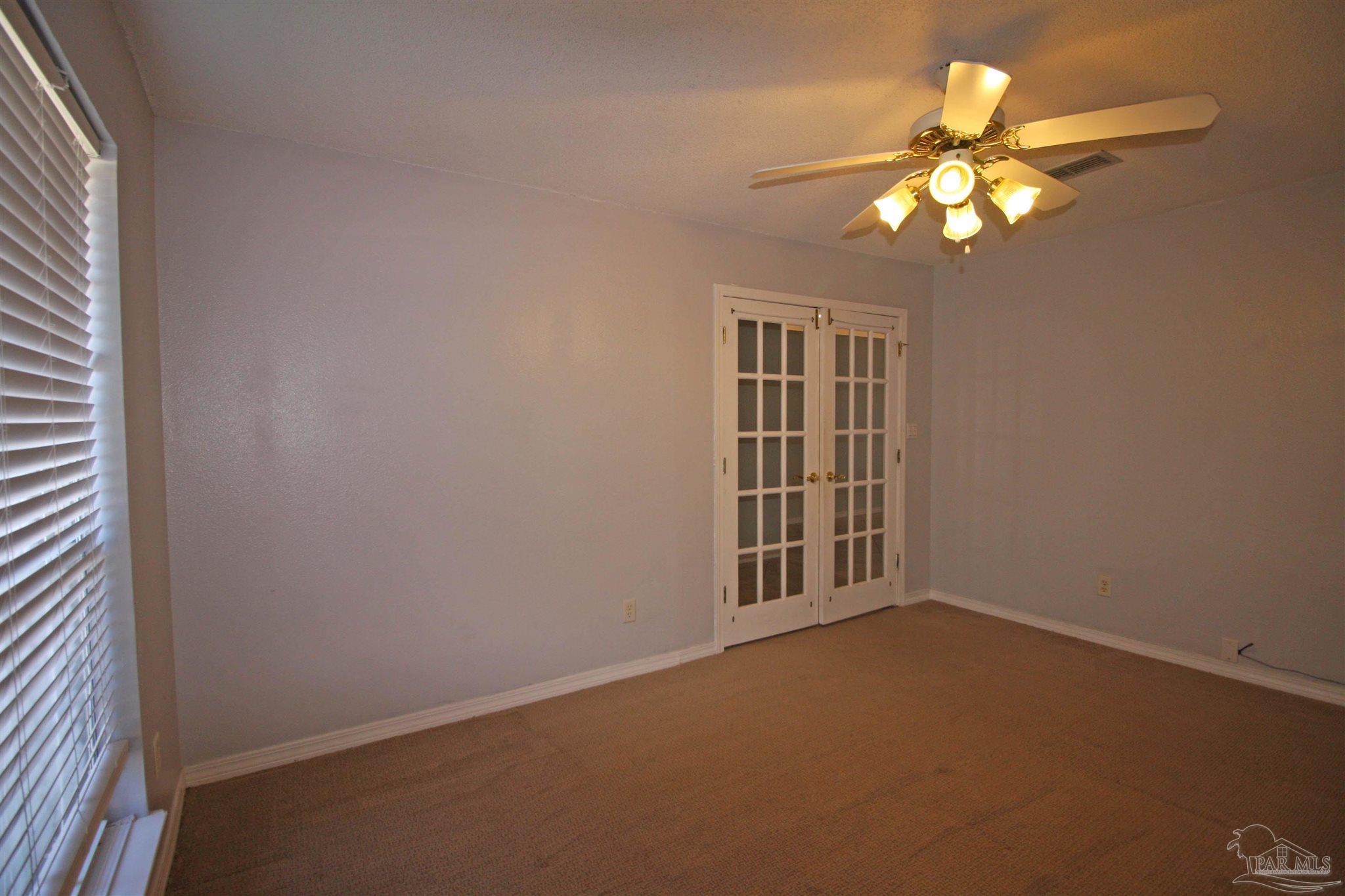 3735 Berrypatch Lane Pace, FL 32571 - Photo 9 of 46 a view of an empty room with a chandelier fan