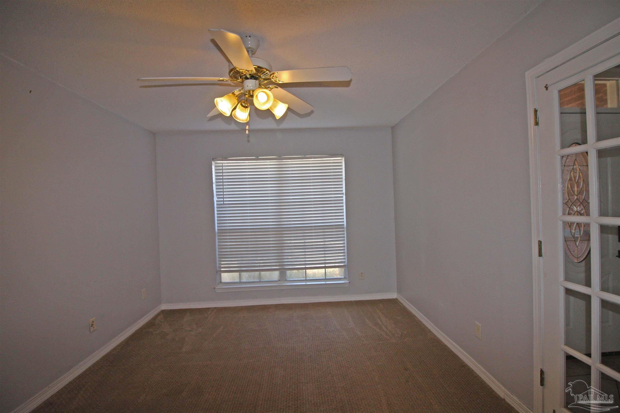 3735 Berrypatch Lane Pace, FL 32571 - Photo 10 of 46 a view of a livingroom with a ceiling fan and window