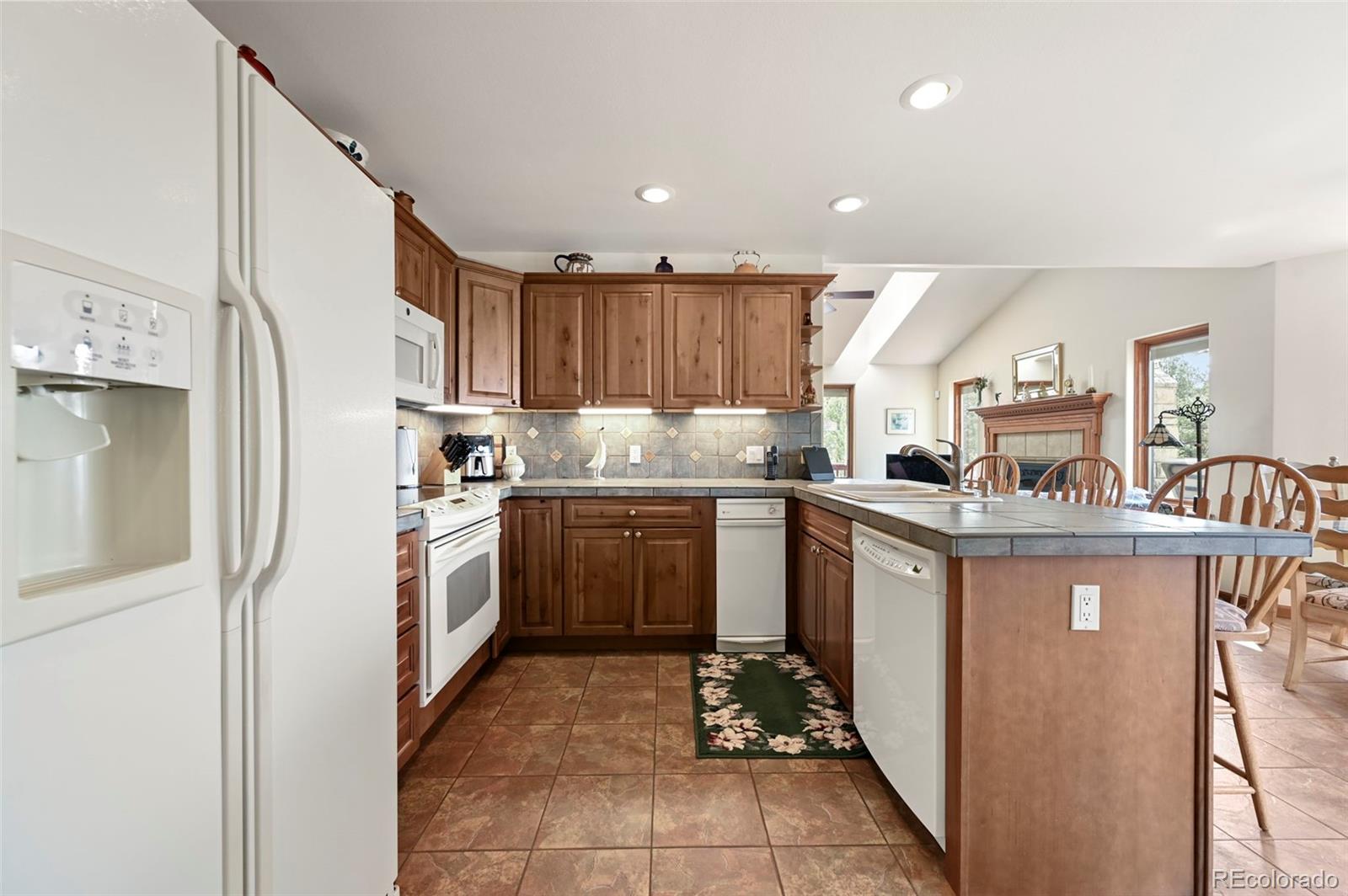 322 Sequoia Road Hartsel, CO 80449 - Photo 13 of 50 a kitchen with a sink refrigerator and cabinets