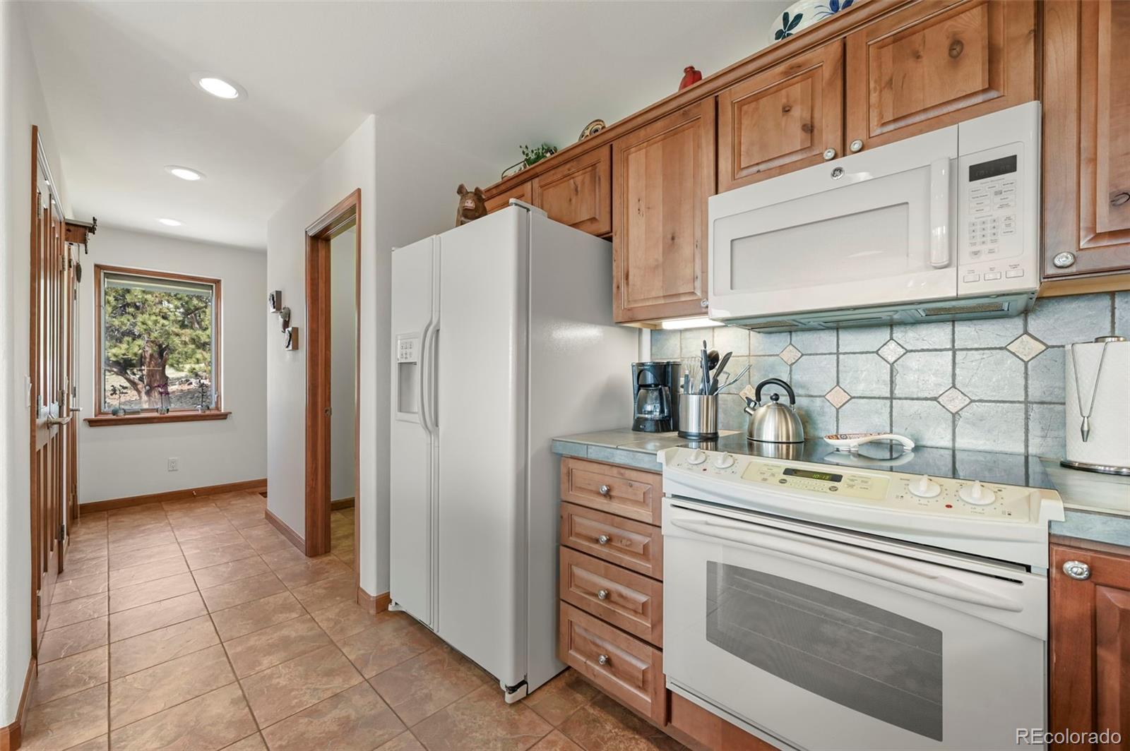 322 Sequoia Road Hartsel, CO 80449 - Photo 14 of 50 a kitchen with stainless steel appliances a refrigerator sink and cabinets