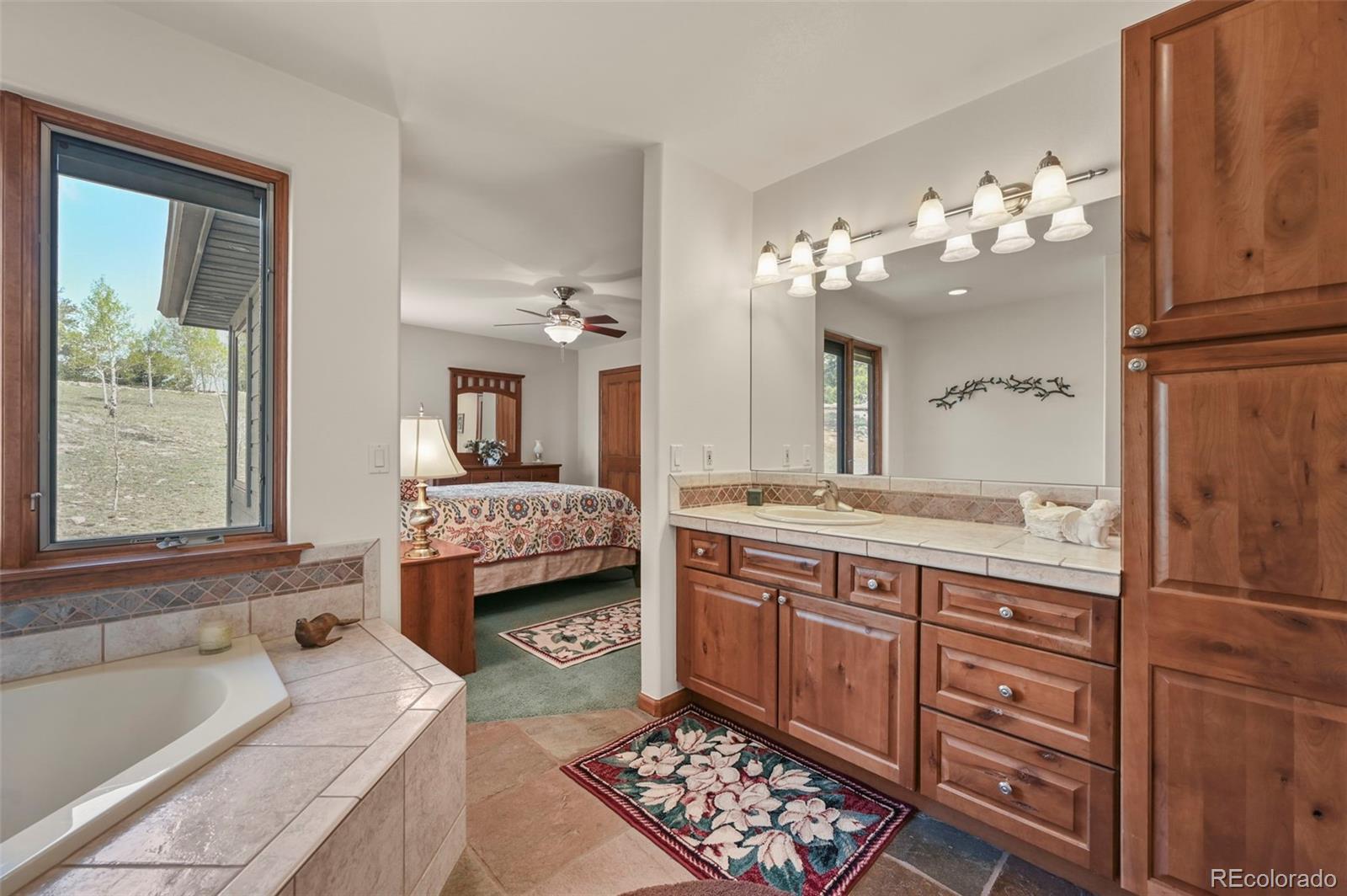 322 Sequoia Road Hartsel, CO 80449 - Photo 18 of 50 a bathroom with a tub sink and mirror