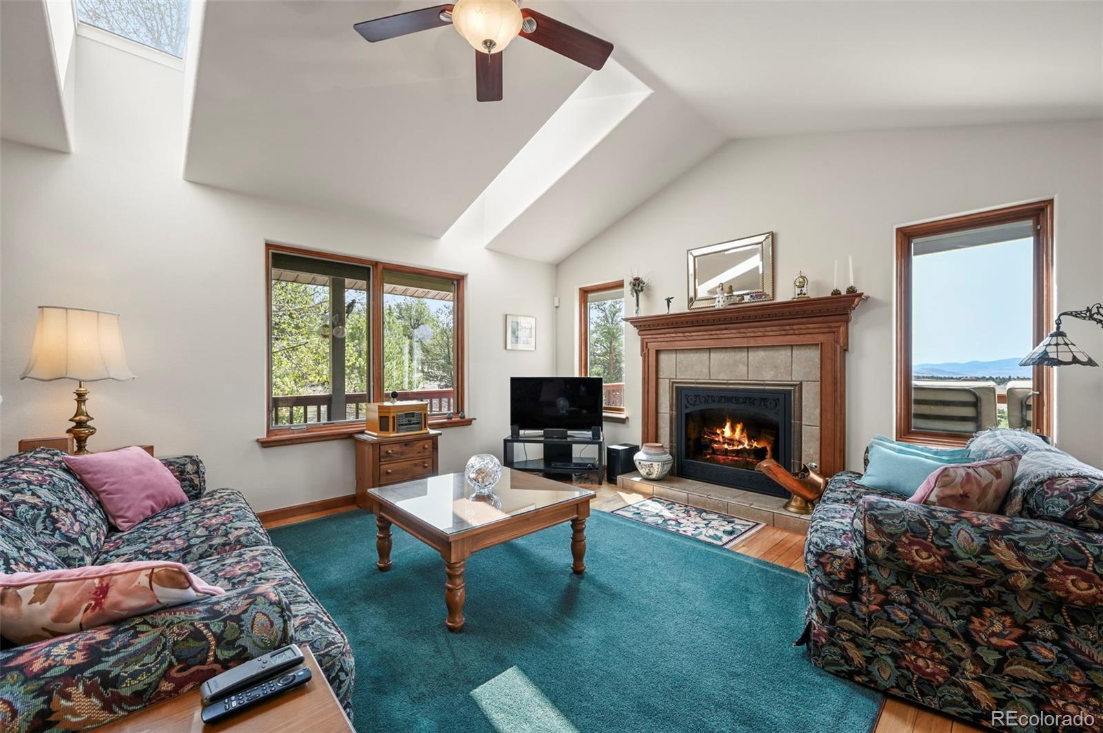 322 Sequoia Road Hartsel, CO 80449 - Photo 7 of 50 a living room with furniture and a fireplace