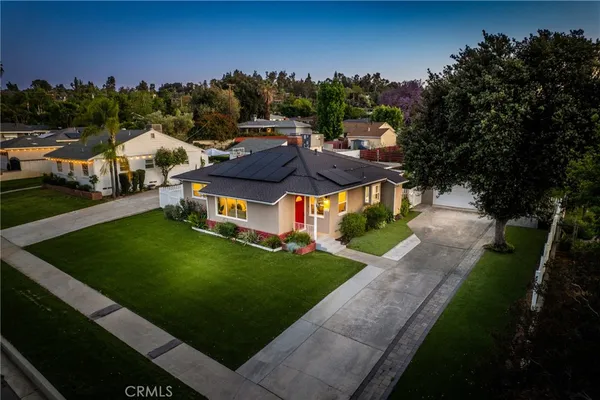 an aerial view of a house with swimming pool garden and fire pit