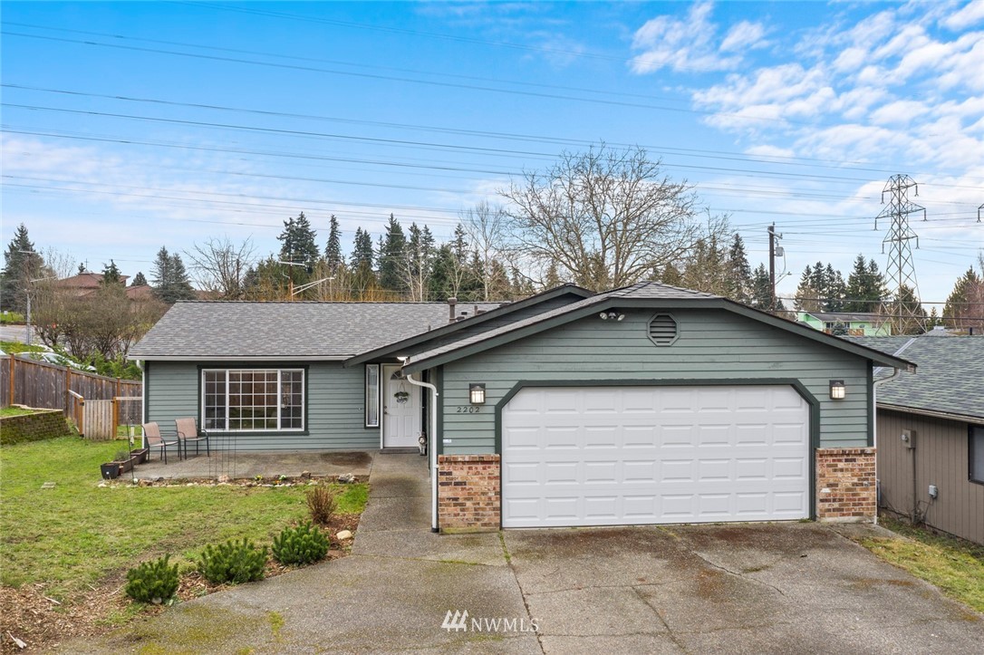 2202 179th Street Southeast Bothell, WA 98012 - Photo 1 of 31 a front view of a house with a garden