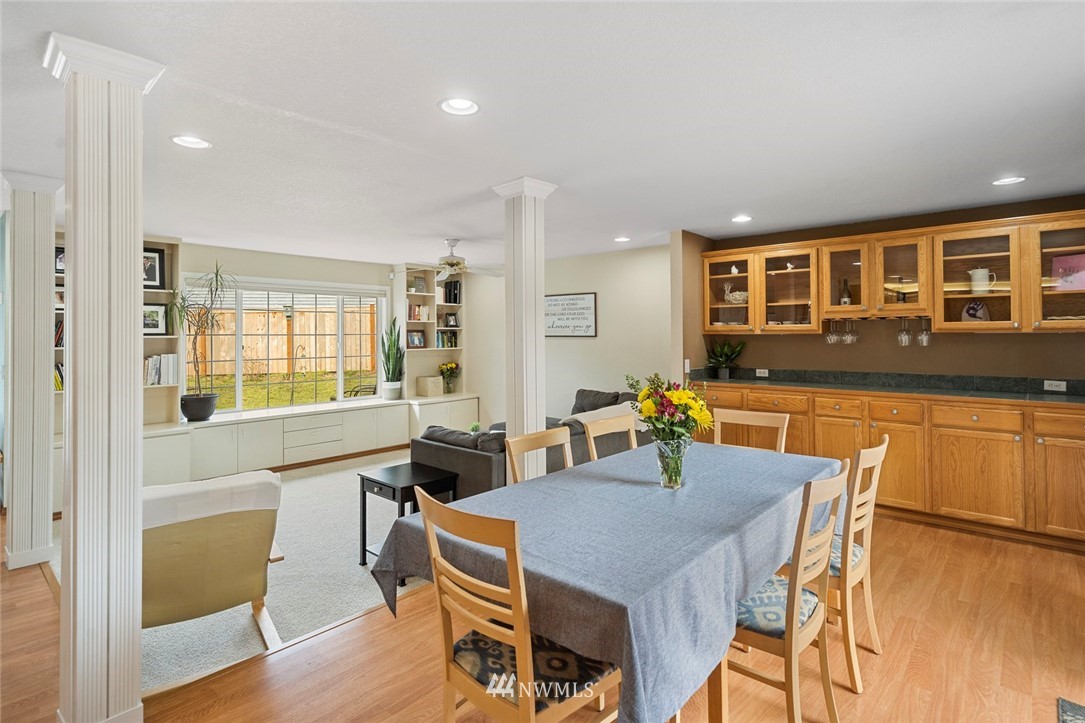 2202 179th Street Southeast Bothell, WA 98012 - Photo 5 of 31 a view of a dining room with furniture window and wooden floor