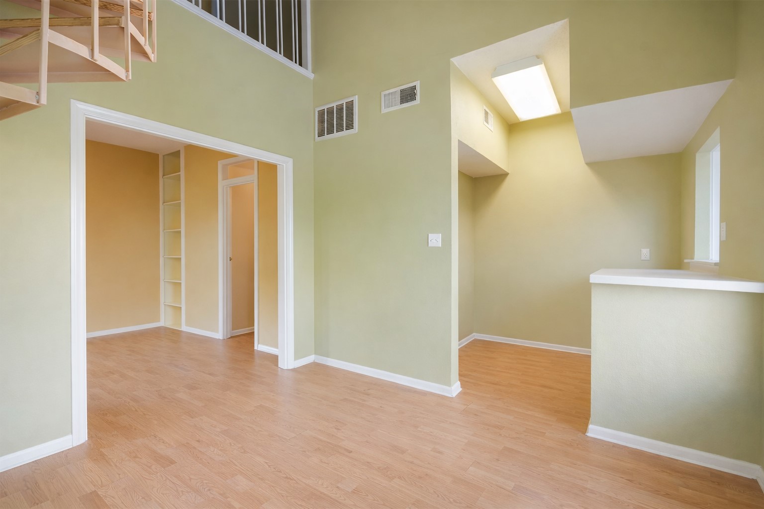 3115 Tom Green Street, Unit 404 Austin, TX 78705 - Photo 5 of 19 Two-story interior featuring wood-finish flooring, a spiral staircase with white railings, and high ceilings