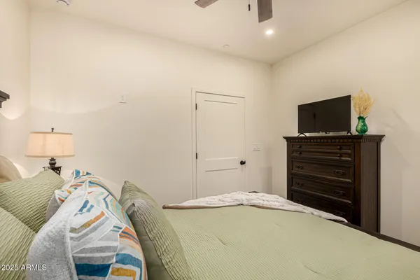 a bedroom with a bed and a flat screen tv