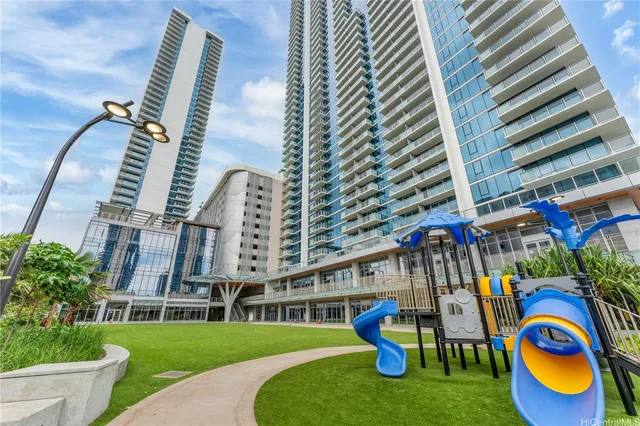 a view of a yard with plants and palm trees