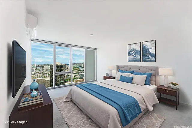 a bedroom with a bed and a flat tv screen next to a window