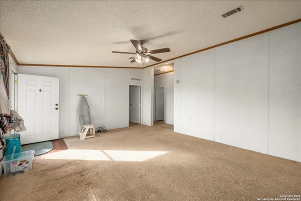 a view of a livingroom with a ceiling fan and window