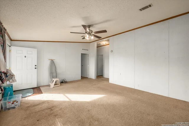 a view of a livingroom with a ceiling fan and window