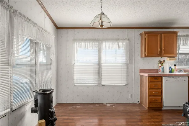 a view of a room with a window and wooden floor
