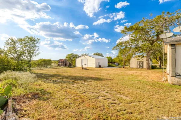 a view of big yard with a house