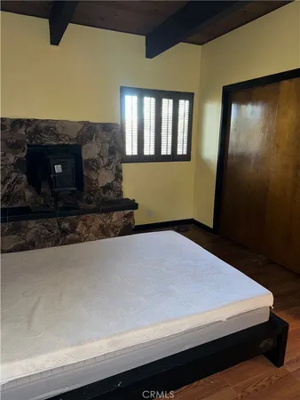 a bedroom with a bed and a fireplace