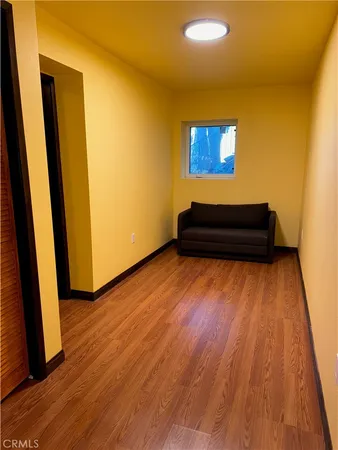 a view of a room with wooden floor and stairs