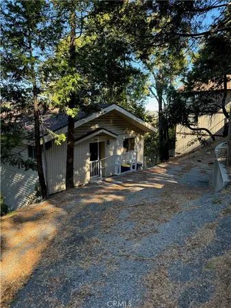 a view of a house with large trees