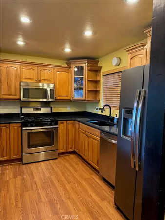 a kitchen with granite countertop a stove and a refrigerator