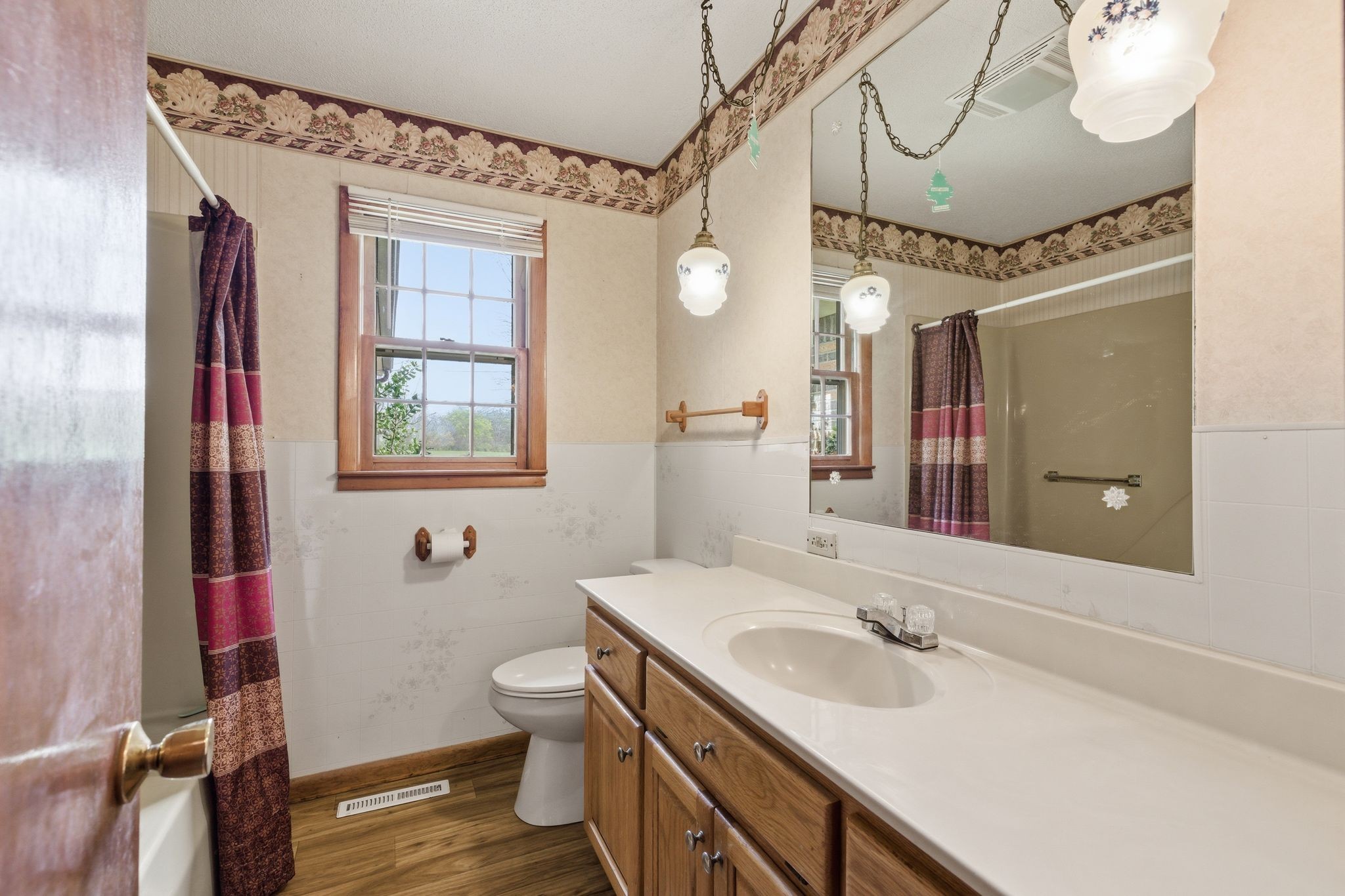 1956 Old Estill Springs Road Winchester, TN 37398 - Photo 14 of 30 a bathroom with a sink and mirror with toilet