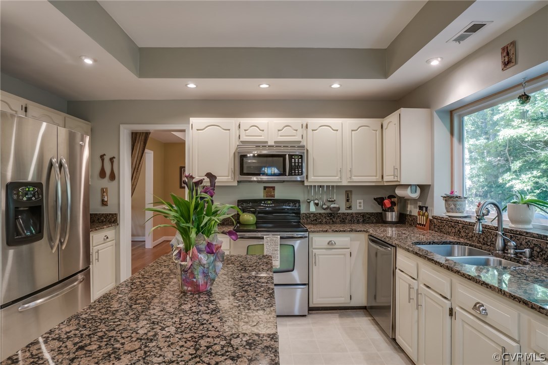 6106 Walnut Landing Way Chester, VA 23831 - Photo 15 of 41 a kitchen with stainless steel appliances granite countertop a refrigerator a stove a sink and white cabinets