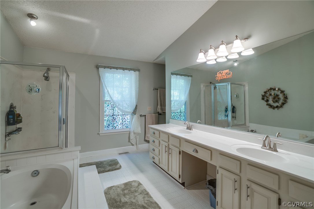 6106 Walnut Landing Way Chester, VA 23831 - Photo 26 of 41 a spacious bathroom with a granite countertop double vanity sink a large mirror and a bathtub