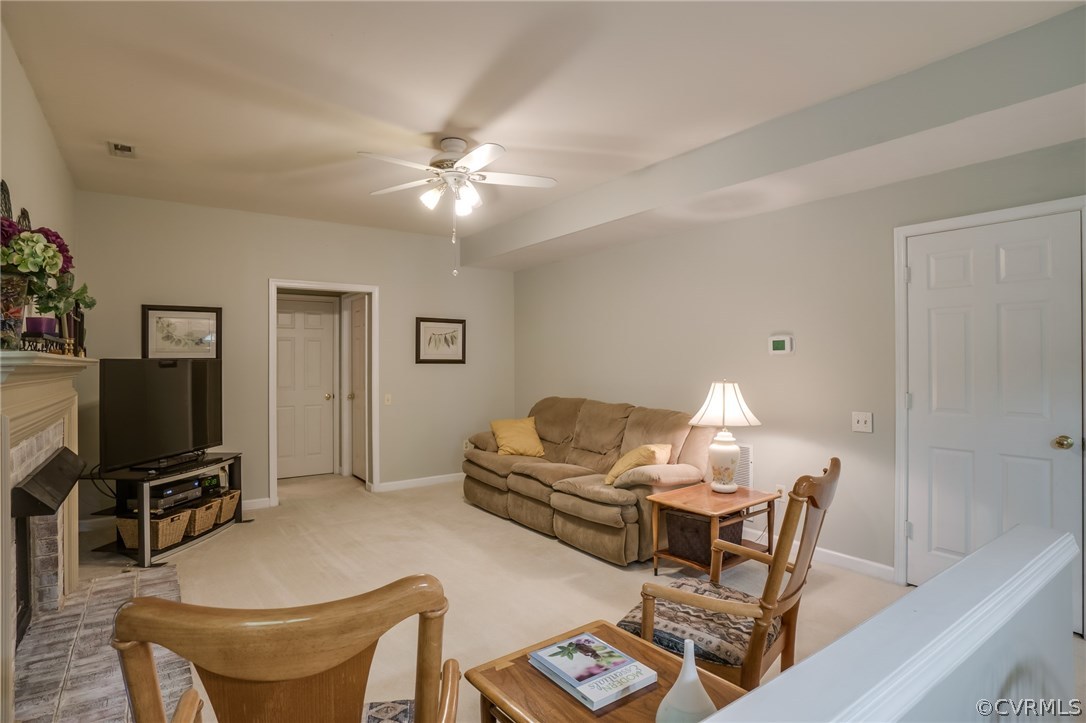 6106 Walnut Landing Way Chester, VA 23831 - Photo 36 of 41 a living room with furniture a piano and a flat screen tv
