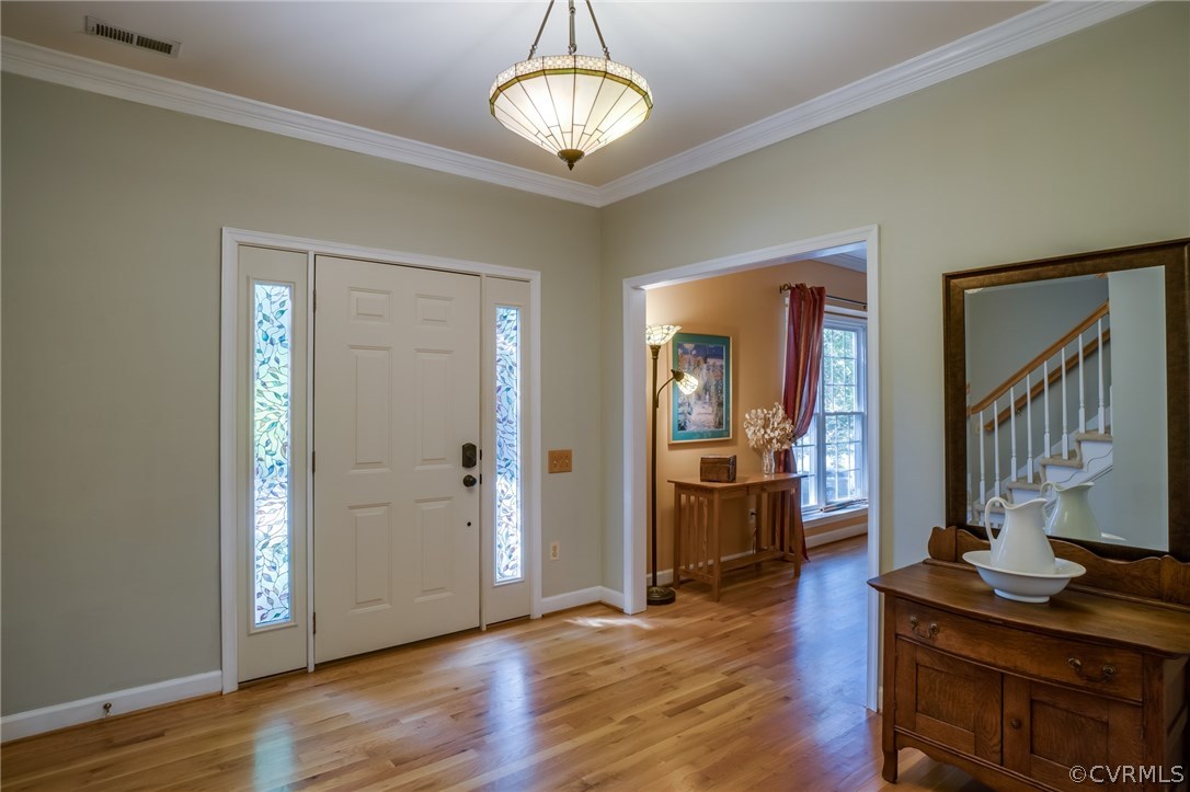 6106 Walnut Landing Way Chester, VA 23831 - Photo 4 of 41 a view of a livingroom with wooden floor and kitchen space