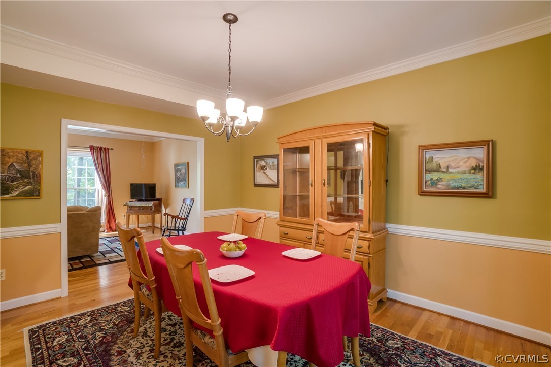 6106 Walnut Landing Way Chester, VA 23831 - Photo 10 of 41 a dining room with a table or chairs and a dining table with wooden floor