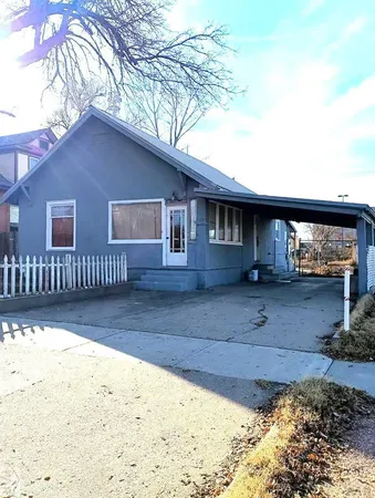 a view of house with backyard and wooden fence