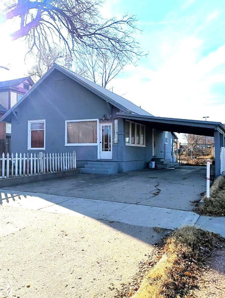 a view of house with backyard and wooden fence