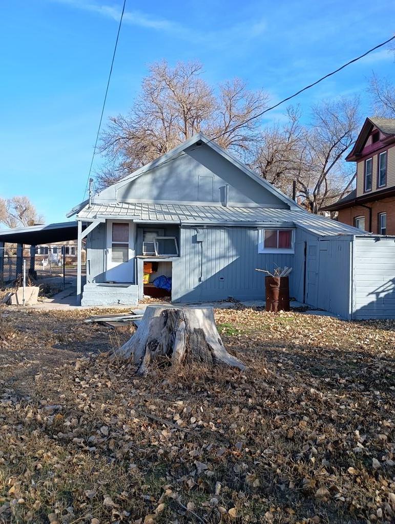 302 South 3rd Street Lamar, CO 81052 - Photo 12 of 12 a front view of a house with a yard covered in snow