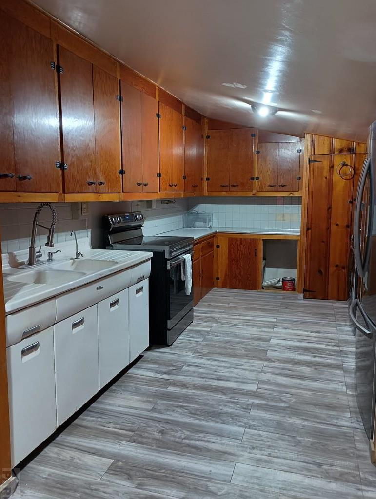 302 South 3rd Street Lamar, CO 81052 - Photo 2 of 12 a kitchen with stainless steel appliances granite countertop a sink a stove and cabinets