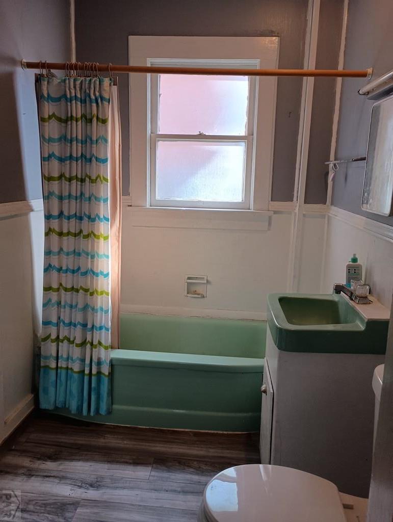 302 South 3rd Street Lamar, CO 81052 - Photo 7 of 12 a bathroom with a toilet a sink and a window