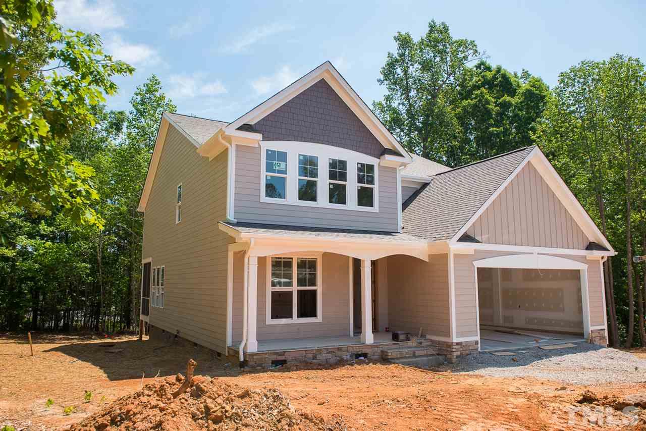 a front view of a house with yard